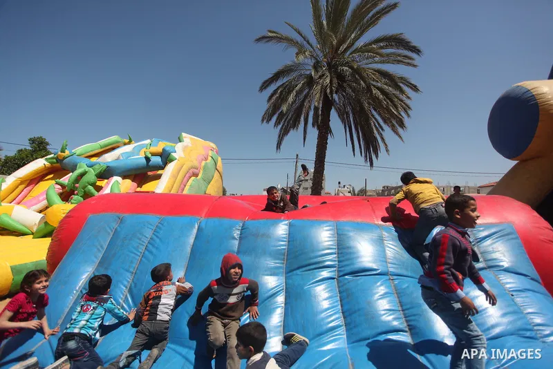 Palestinian children take part in a celebration to mark the Children's Day, at University College of Applied Sciences in Gaza city on April 5, 2015. Photo by Ashraf Amra