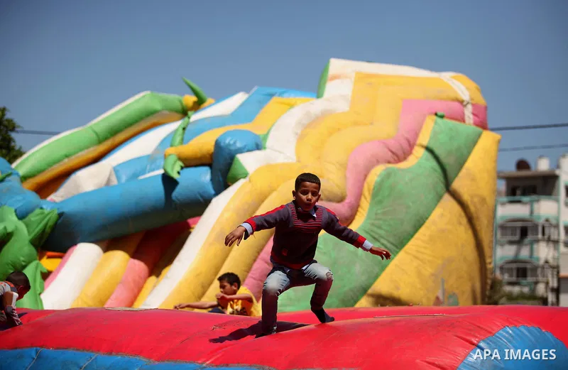 Palestinian children take part in a celebration to mark the Children's Day, at University College of Applied Sciences in Gaza city on April 5, 2015. Photo by Ashraf Amra