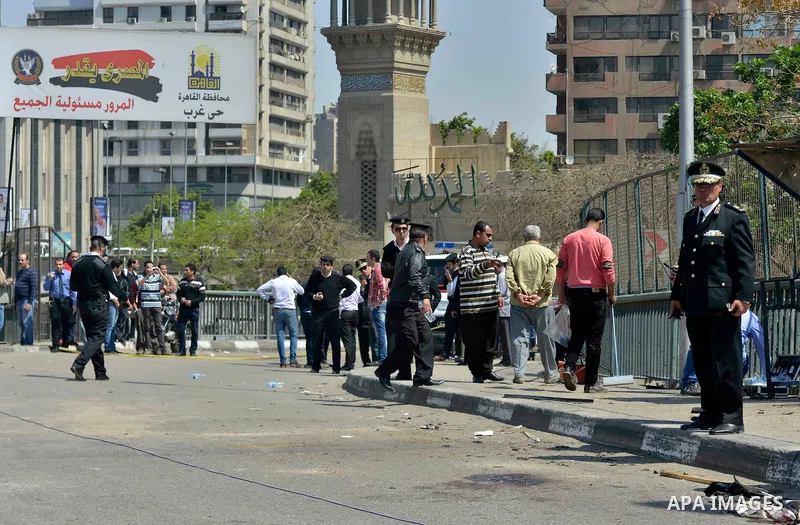 Egyptian policemen stand guard at the site of a bomb explosion next to a checkpoint on a side of the May 15 bridge exploded in the Cairo's neighbourhood of Zamalek on April 5, 2015. An officer was killed and two people w...