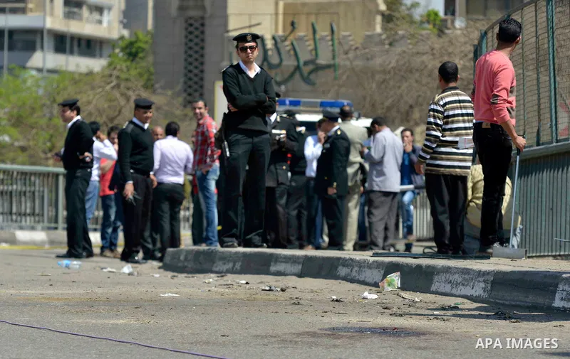 Egyptian policemen stand guard at the site of a bomb explosion next to a checkpoint on a side of the May 15 bridge exploded in the Cairo's neighbourhood of Zamalek on April 5, 2015. An officer was killed and two people w...