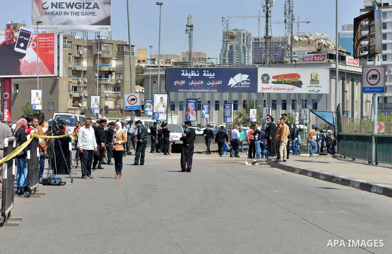 Egyptian policemen stand guard at the site of a bomb explosion next to a checkpoint on a side of the May 15 bridge exploded in the Cairo's neighbourhood of Zamalek on April 5, 2015. An officer was killed and two people w...
