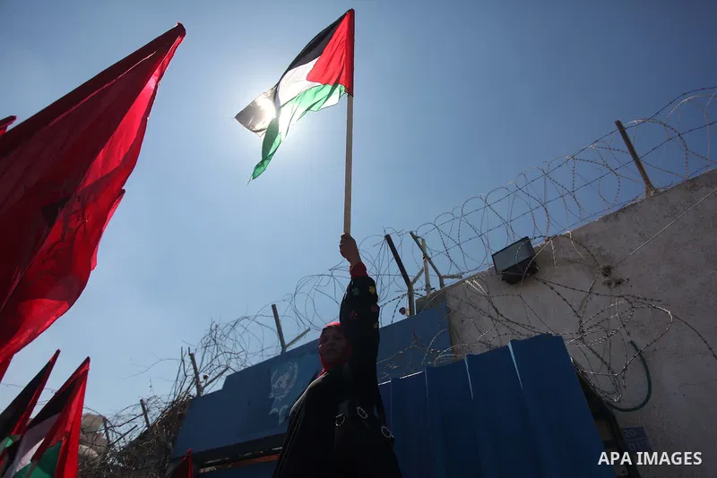 Palestinian supporters of the Democratic Front for the Liberation of Palestine (DFLP), shout slogans as they hold banners during a gathering in solidarity with the Palestinians living in Syria's Yarmouk camp, which is be...