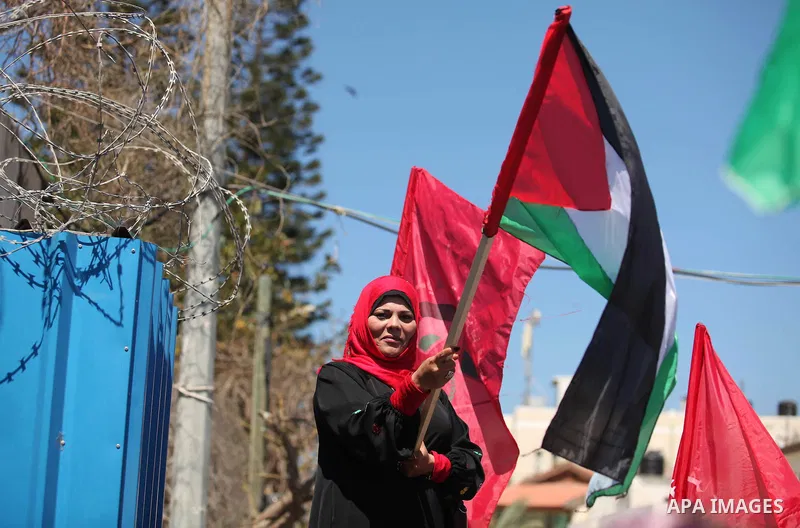 Palestinian supporters of the Democratic Front for the Liberation of Palestine (DFLP), shout slogans as they hold banners during a gathering in solidarity with the Palestinians living in Syria's Yarmouk camp, which is be...