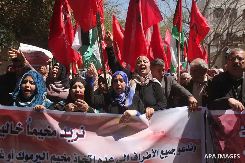 Palestinian supporters of the Democratic Front for the Liberation of Palestine (DFLP), shout slogans as they hold banners during a gathering in solidarity with the Palestinians living in Syria's Yarmouk camp, which is be...