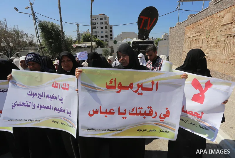 Palestinians take part a protest to show solidarity with the Palestinians living in Syria's Yarmouk camp, which is besieged by government forces and has been largely overrun by jihadist fighters, in front of the Legislat...
