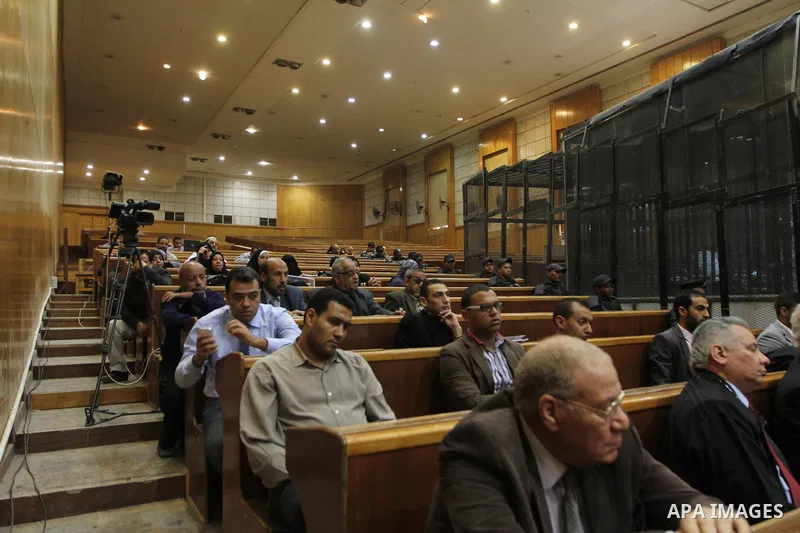 Relatives of Egyptians who were killed in the 'Port Said Massacre' attend a trial of defendants in Cairo on April 6, 2015. The defendants were originally given sentences ranging from 15 years to life in prison. They were...