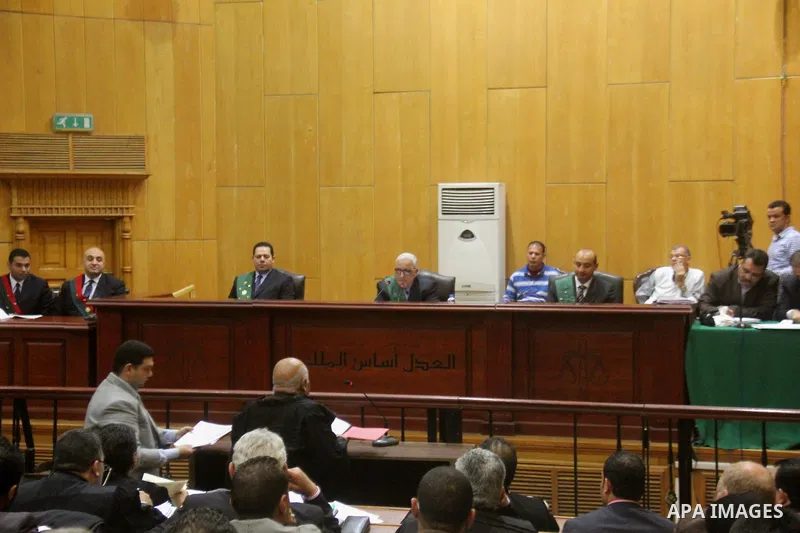 The Judge speaks during the trial of suspects in the 'Port Said Massacre' case in Cairo on April 6, 2015. The defendants were originally given sentences ranging from 15 years to life in prison. They were convicted of the...
