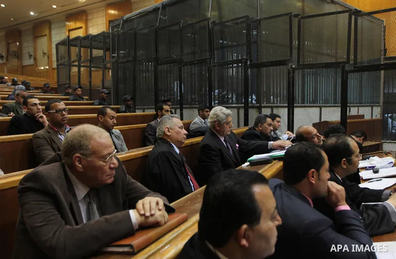Relatives of Egyptians who were killed in the 'Port Said Massacre' attend a trial of defendants in Cairo on April 6, 2015. The defendants were originally given sentences ranging from 15 years to life in prison. They were...