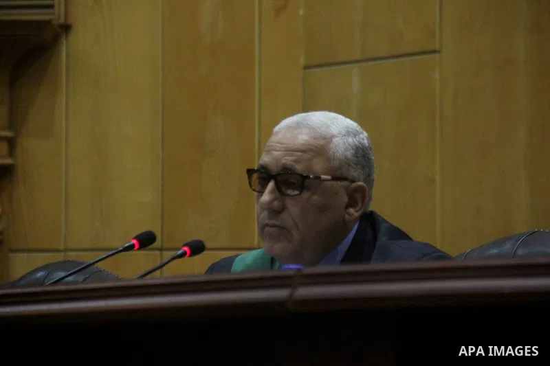 The Judge speaks during the trial of suspects in the 'Port Said Massacre' case in Cairo on April 6, 2015. The defendants were originally given sentences ranging from 15 years to life in prison. They were convicted of the...