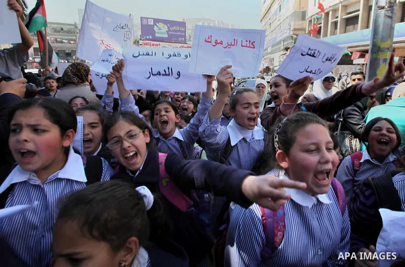 Palestinians take part a protest to show solidarity with the Palestinians living in Syria's Yarmouk camp, which is besieged by government forces and has been largely overrun by jihadist fighters, in the West bank city of...