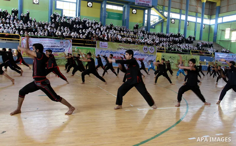 Palestinian students demonstrate their skills during the sports festival organised by the ministry of education in Rafah in the southern Gaza Strip, April 6, 2015. Photo by Abed Rahim Khatib