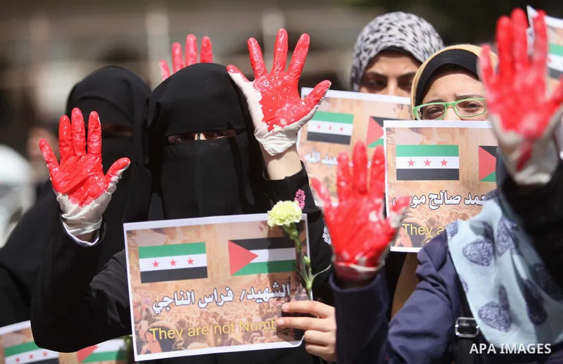 Palestinian students take part a protest to show solidarity with the Palestinians living in Syria's Yarmouk camp, which is besieged by government forces and has been largely overrun by jihadist fighters, in Gaza city on...