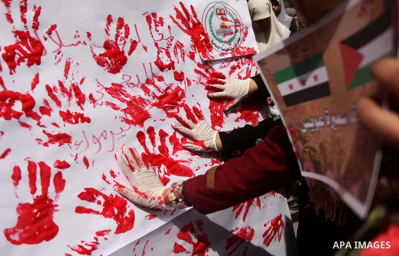 Palestinian students take part a protest to show solidarity with the Palestinians living in Syria's Yarmouk camp, which is besieged by government forces and has been largely overrun by jihadist fighters, in Gaza city on...