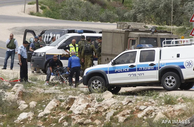 Israeli security forces and forensics surround the body of a Palestinian man, in the West Bank village of Sinjil, who was killed by Israeli forces after injuring two Israelis in a stabbing attack near the entrance to the...