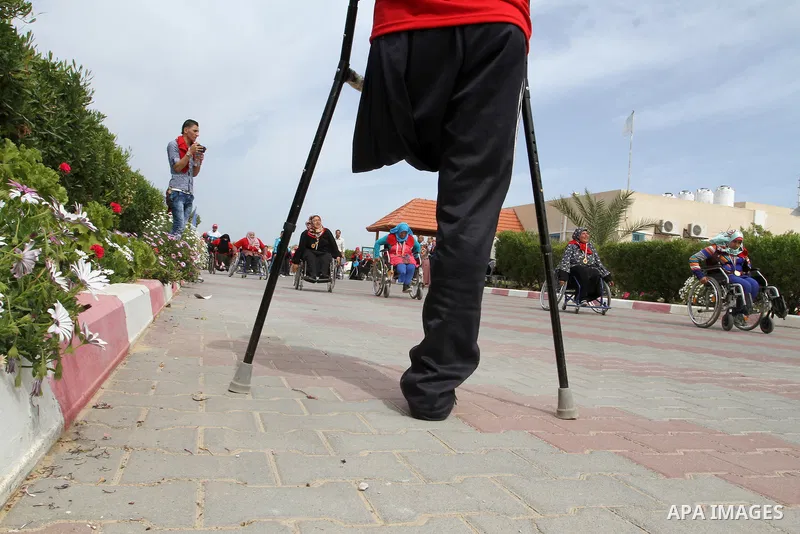 Disabled Palestinians participate in a race during an event organized by United Nations at a U.N-run training center in Khan Younis in the southern Gaza Strip April 8, 2015. The event was aimed at raising awareness on th...