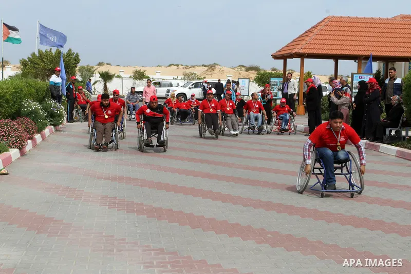 Disabled Palestinians participate in a race during an event organized by United Nations at a U.N-run training center in Khan Younis in the southern Gaza Strip April 8, 2015. The event was aimed at raising awareness on th...