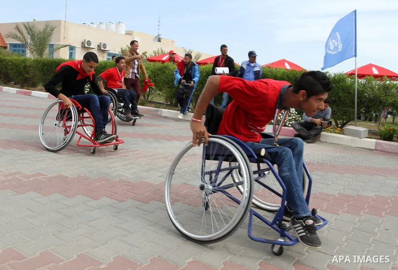 Disabled Palestinians participate in a race during an event organized by United Nations at a U.N-run training center in Khan Younis in the southern Gaza Strip April 8, 2015. The event was aimed at raising awareness on th...