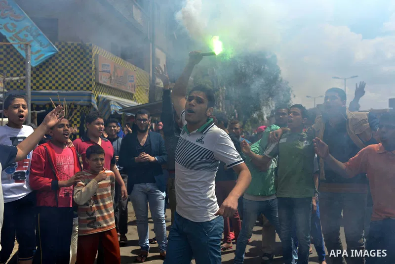 An Egyptian supporter of Muslim Brotherhood and ousted president Mohammed Morsi, lights flares during a protest against military rule in al-Matariya district, near Cairo on April 10, 2015. Photo by Amr Sayed