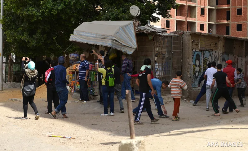Supporters of Muslim Brotherhood and ousted president Mohammed Morsi throw stones at Egyptian riot police during clashes following a protest against military rule in al-Matariya district, near Cairo on April 10, 2015. Ph...