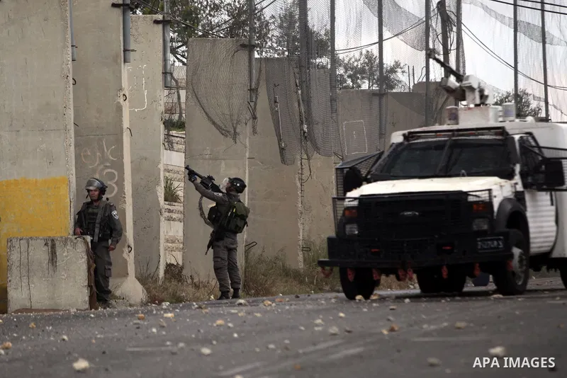 Israeli security forces take their position during clashes with Palestinian stone-throwers following the funeral of 32-year old Ziad Awad, who was shot dead by Israeli troops when they opened fire during the funeral of h...