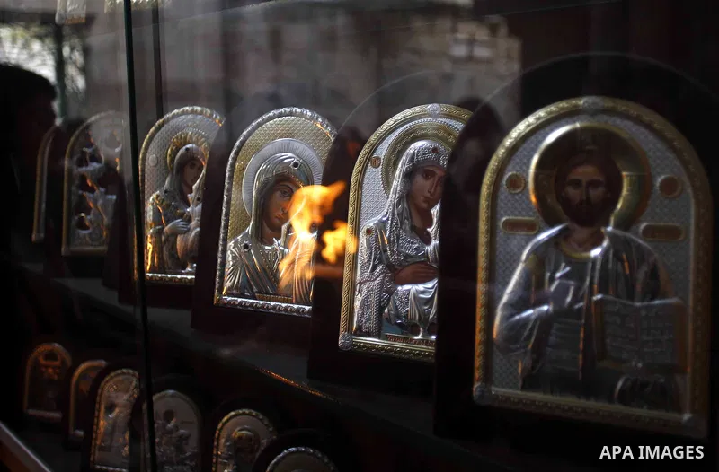 Christian Orthodox worshipers hold up candles lit from the "Holy Fire" as thousands gather in the Church of the Holy Sepulchre in Jerusalem's Old City, on April 11, 2015 during the Orthodox Easter ceremony of the "Holy F...