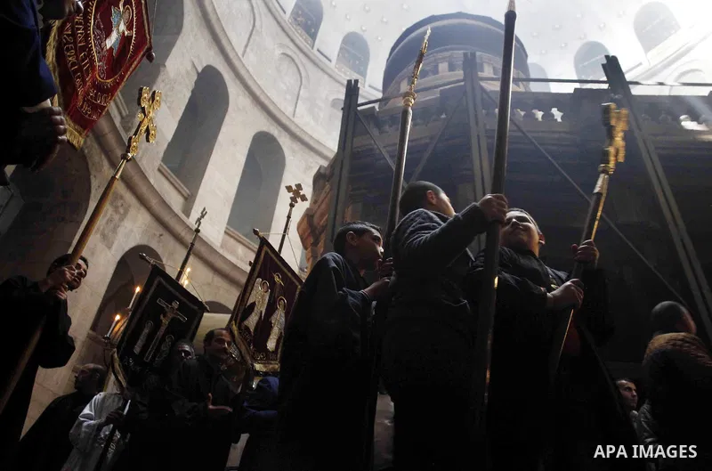 Christian Orthodox worshipers hold up candles lit from the "Holy Fire" as thousands gather in the Church of the Holy Sepulchre in Jerusalem's Old City, on April 11, 2015 during the Orthodox Easter ceremony of the "Holy F...