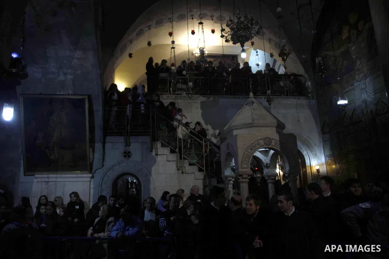 Christian Orthodox worshipers hold up candles lit from the "Holy Fire" as thousands gather in the Church of the Holy Sepulchre in Jerusalem's Old City, on April 11, 2015 during the Orthodox Easter ceremony of the "Holy F...