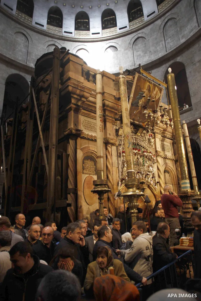 Christian Orthodox worshipers hold up candles lit from the "Holy Fire" as thousands gather in the Church of the Holy Sepulchre in Jerusalem's Old City, on April 11, 2015 during the Orthodox Easter ceremony of the "Holy F...