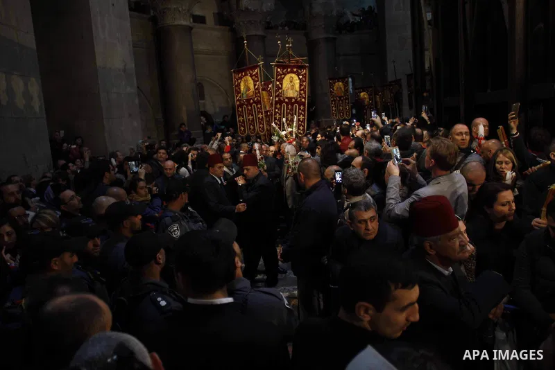 Christian Orthodox worshipers hold up candles lit from the "Holy Fire" as thousands gather in the Church of the Holy Sepulchre in Jerusalem's Old City, on April 11, 2015 during the Orthodox Easter ceremony of the "Holy F...
