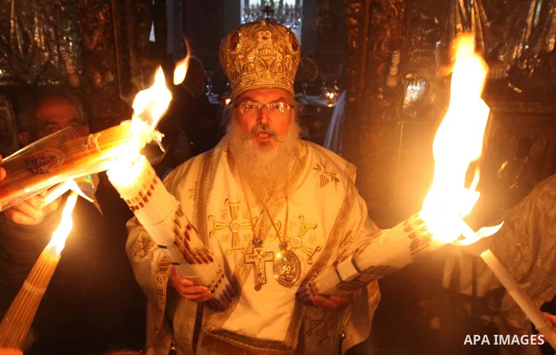 Christian pilgrims hold candles at the church of the Holy Sepulcher, traditionally believed to be the burial site of Jesus Christ, during the ceremony of the Holy Fire in in Bethlehem City, on April 11, 2015. Thousands o...