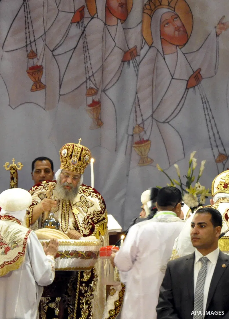 Coptic Pope Tawadros II, head of the Coptic Orthodox church, takes part in a ritual as part of a Coptic Orthodox Easter mass at the main cathedral in Cairo April 11, 2015. Photo by Amr Sayed