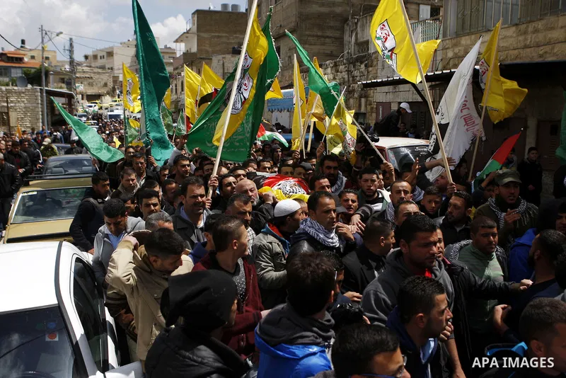 Mourners carry the body of 27-year-old Palestinian Mohammed Jasser Karakra, during his funeral in the Sinjil village, in the occupied West Bank city of Ramallah, on April 13, 2015. Karakra stabbed two Israeli soldiers in...
