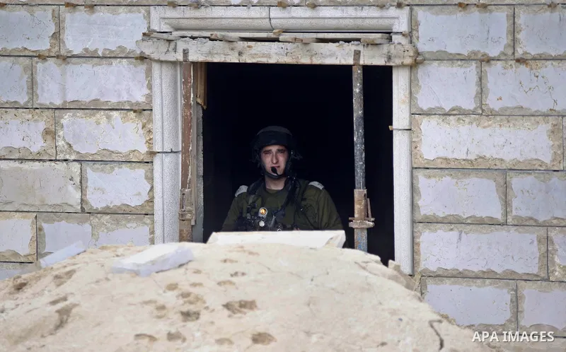 A member of Israeli security forces takes postion during clashes with Palestinian youths following the funeral of 27-year-old Palestinian Mohammed Jasser Karakra, in the Sinjil village, in the occupied West Bank city of...