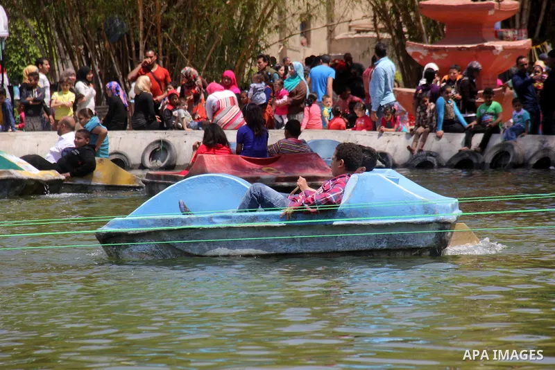 Egyptian children play at the Jabanese botanical garden in Helwan city, north of Cairo on April 13, 2015. Egyptians celebrate the Sham El Nessim, or the Festival of Spring Breeze, which marks the beginning of spring. Pho...
