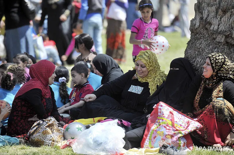 Egyptian children with their familys sit at a garden in Cairo on April 13, 2015. Egyptians celebrate the Sham El Nessim, or the Festival of Spring Breeze, which marks the beginning of spring. Photo by Amr Sayed