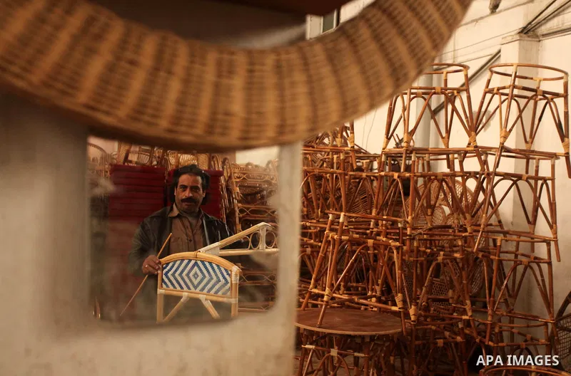 A Palestinian man works on bamboo furniture at his workshop in Gaza city on April 16, 2015. Bamboo is a product of southeast Asian countries and before the Israeli blockade of the Gaza Strip, Gaza traders used to bring i...