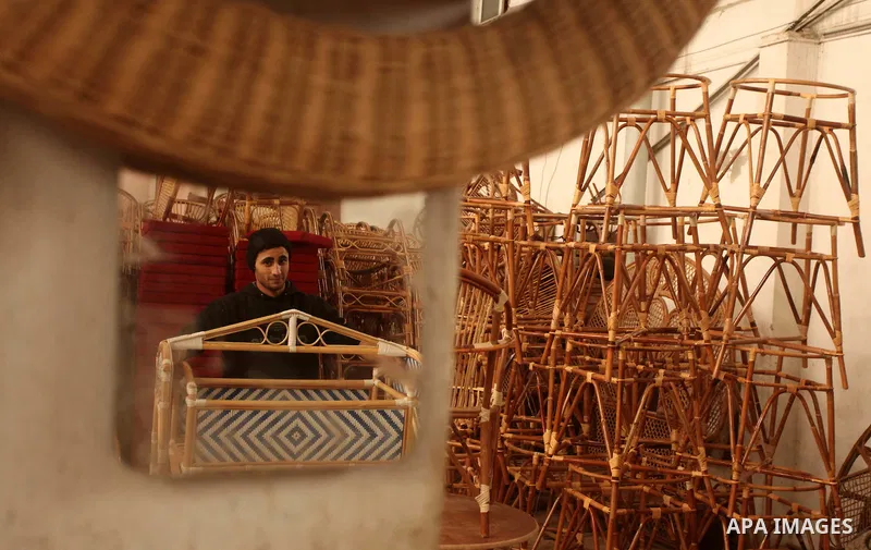 A Palestinian man works on bamboo furniture at his workshop in Gaza city on April 16, 2015. Bamboo is a product of southeast Asian countries and before the Israeli blockade of the Gaza Strip, Gaza traders used to bring i...