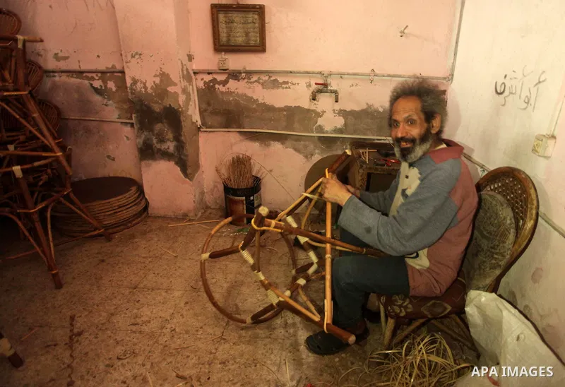 A Palestinian man works on bamboo furniture at his workshop in Gaza city on April 16, 2015. Bamboo is a product of southeast Asian countries and before the Israeli blockade of the Gaza Strip, Gaza traders used to bring i...