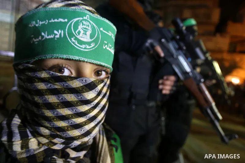Palestinian members of al-Qassam Brigades stand near a model of a Hamas manufactored A1b drone, during a ceremony marking the eleventh anniversary of the death of former Hamas leader Abdel Aziz al-Rantissi, in the easter...