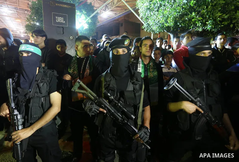 Palestinian members of al-Qassam Brigades stand near a model of a Hamas manufactored A1b drone, during a ceremony marking the eleventh anniversary of the death of former Hamas leader Abdel Aziz al-Rantissi, in the easter...