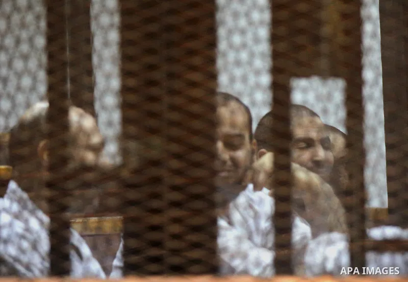 Egyptian suspects in the case of Suez terrorist cell sit inside court's cage during their trial, at a court, in Cairo, Egypt on April 18, 2015. Photo by Amr Sayed