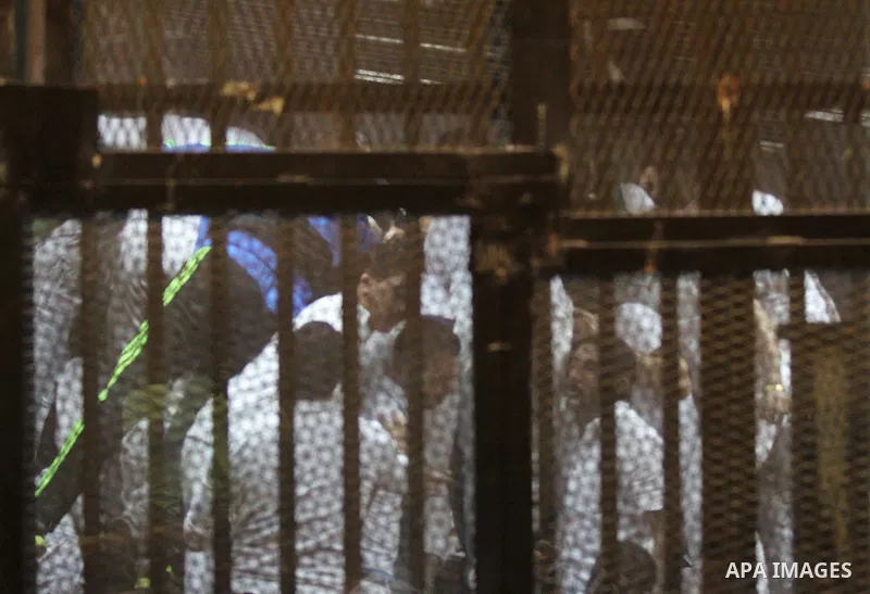 Egyptian Defendants on trial for the deaths in a riot following a football match in Port Said in February 2012, sit behind bars as the court upholds 11 death sentences for some of the accused, Cairo, Egypt, 19 April 2015...