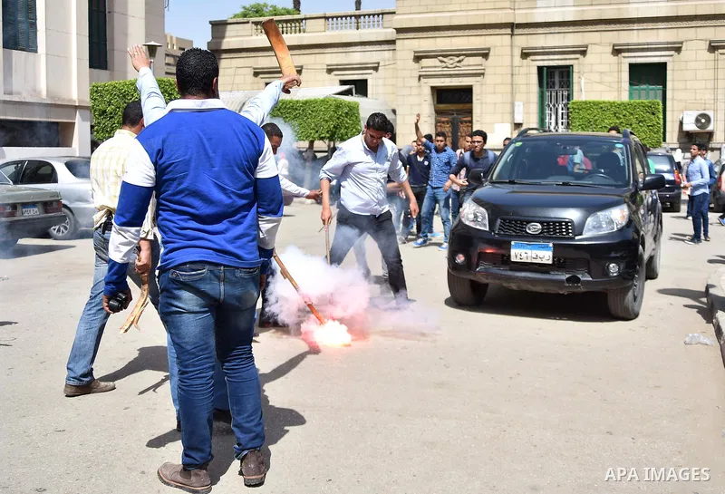 Smoke rises as clashes brokeout between Egyptian students who support ousted President Mohamed Morsi and the Muslim Brotherhood, and Administrative security personnel at Cairo University on April 19, 2015. Administrative...