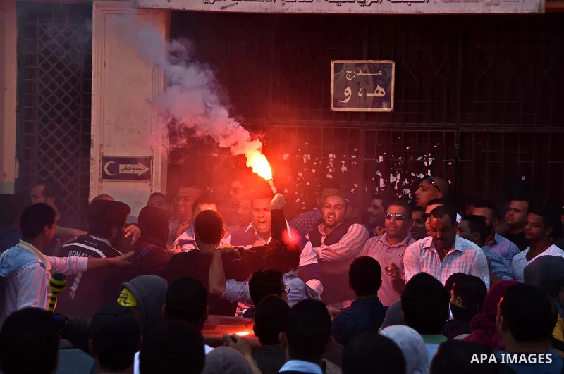 Egyptian students who support ousted President Mohamed Morsi and the Muslim Brotherhood, light flares during a demonstration at Cairo University on April 19, 2015. Administrative security personnel in Cairo University ar...