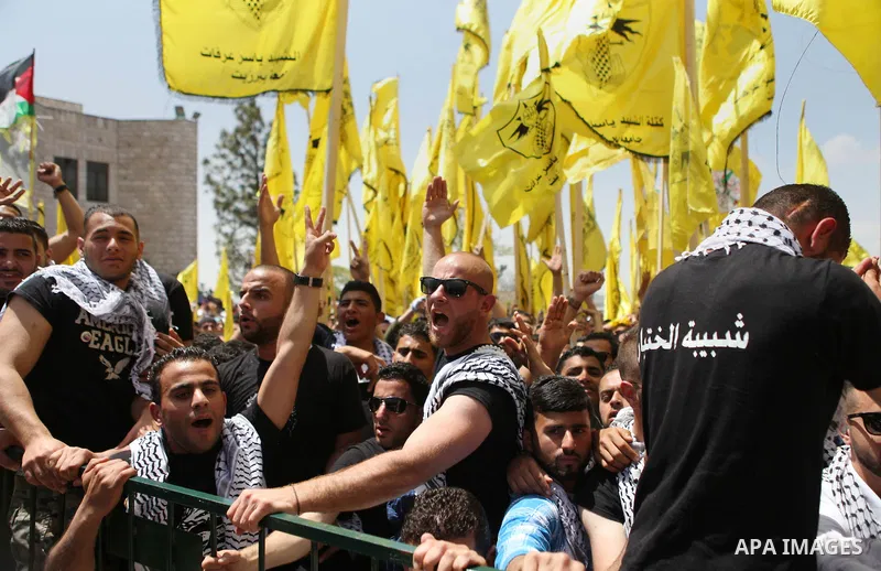 Palestinian supporters of the Islamic Hamas movement and Fatah movement attend a rally prior to the Student Council elections at Birzeit University, on the outskirts of the city of Ramallah in the West Bank on April 21 2...