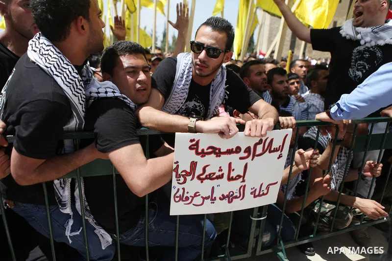Palestinian supporters of the Islamic Hamas movement and Fatah movement attend a rally prior to the Student Council elections at Birzeit University, on the outskirts of the city of Ramallah in the West Bank on April 21 2...