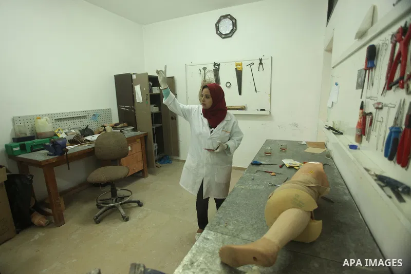 Lana Al-Kronz, 26-year-old Palestinian specialist of prosthetic works on an artificial leg at a center of prosthetic limbs, in Gaza City on April 21, 2015. Al-Krunz is the first Palestinian woman which makes the prosthet...