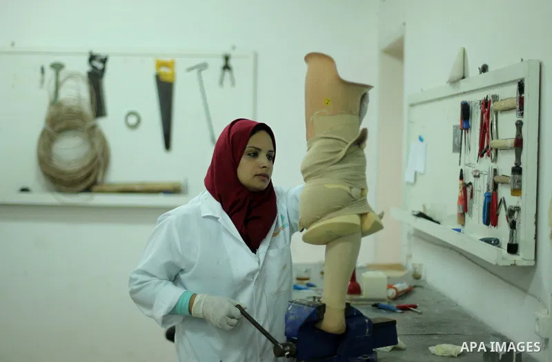 Lana Al-Kronz, 26-year-old Palestinian specialist of prosthetic works on an artificial leg at a center of prosthetic limbs, in Gaza City on April 21, 2015. Al-Krunz is the first Palestinian woman which makes the prosthet...