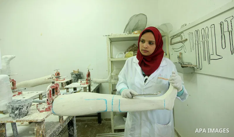 Lana Al-Kronz, 26-year-old Palestinian specialist of prosthetic works on an artificial leg at a center of prosthetic limbs, in Gaza City on April 21, 2015. Al-Krunz is the first Palestinian woman which makes the prosthet...
