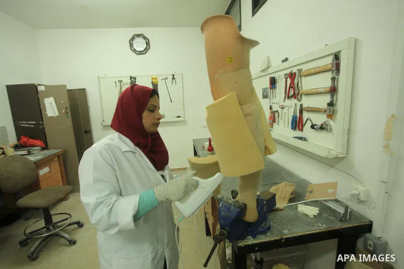 Lana Al-Kronz, 26-year-old Palestinian specialist of prosthetic works on an artificial leg at a center of prosthetic limbs, in Gaza City on April 21, 2015. Al-Krunz is the first Palestinian woman which makes the prosthet...